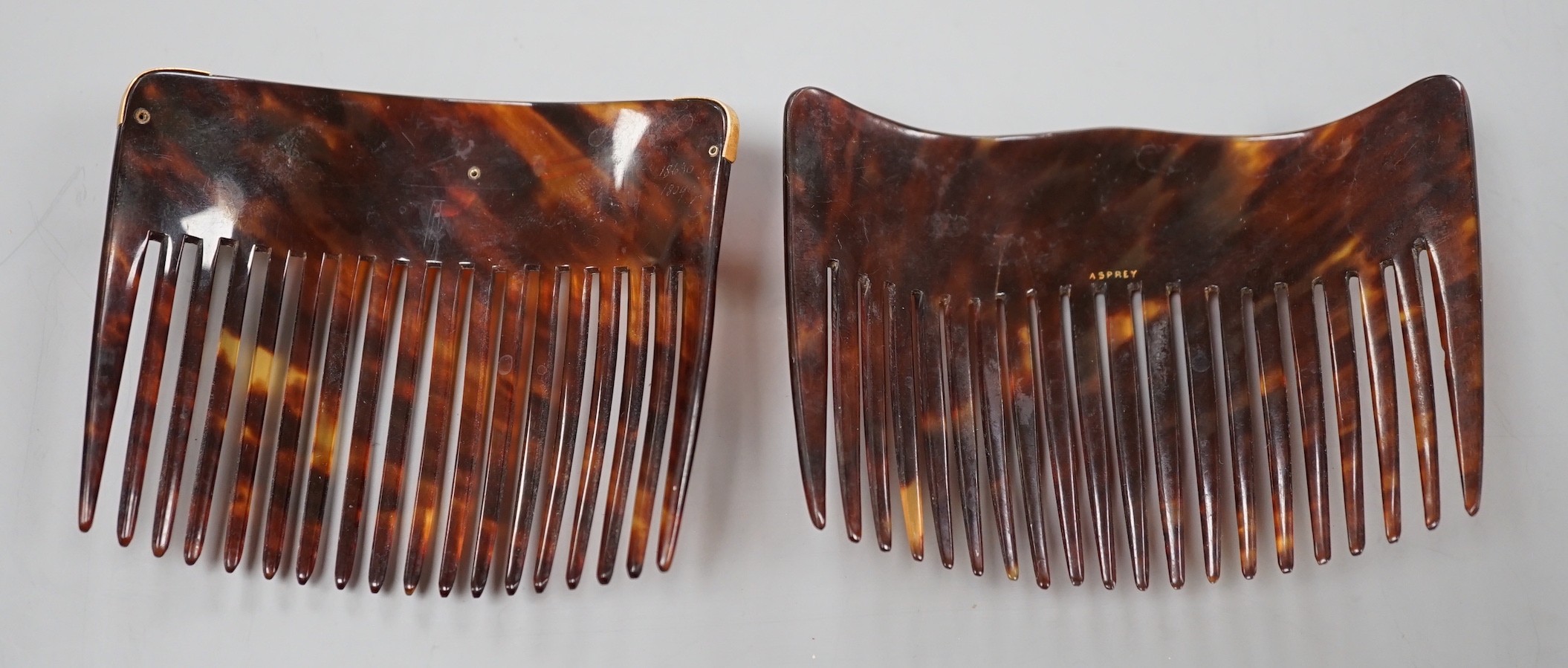 An early 20th century 9ct and mother of pearl mounted tortoiseshell hair comb, by Murrle Bennett & Co, width 93mm and one other tortoiseshell hair comb by Asprey.